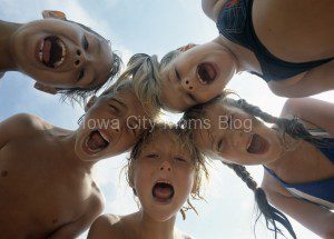 Five children looking down into the camera screaming