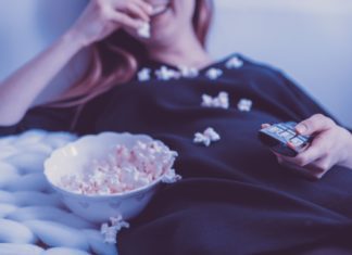 A woman binge watching a TV show