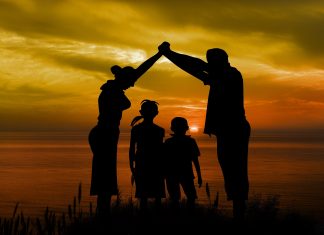 A photo of a family at sunset
