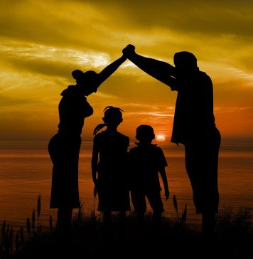 A photo of a family at sunset