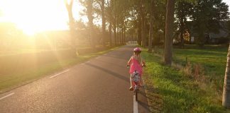 A child biking with a helmet on