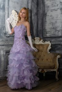woman in purple ball gown with lacy fan 