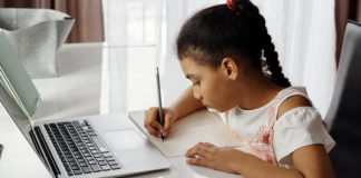 image of little girl in front of a laptop