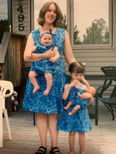 Woman and daughters in matching dresses