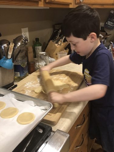 Photo: child rolling hamentaschen cooking dough