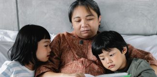 a mother reading to her children