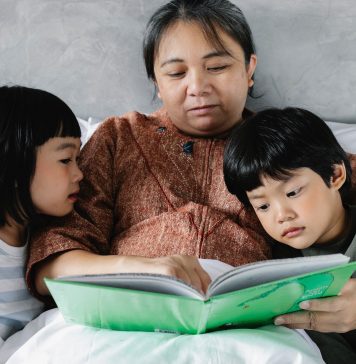 a mother reading to her children
