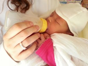 Formula feeding hacks: a baby eating from a bottle