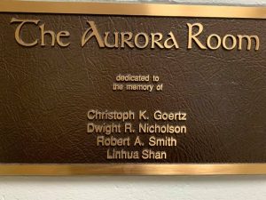 Plaque designating that the Aurora Room is dedicated to victims