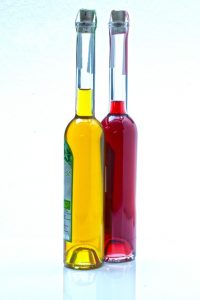Two glass bottles, with yellow liquid and red liquid