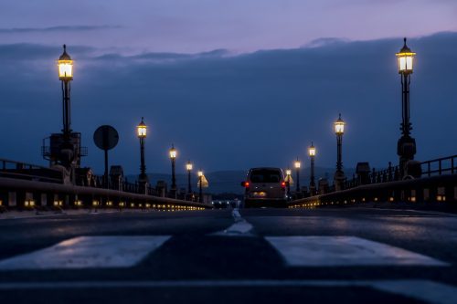 Image: Car driving over a bridge at dawn 